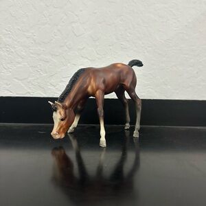 Breyer grazing foal